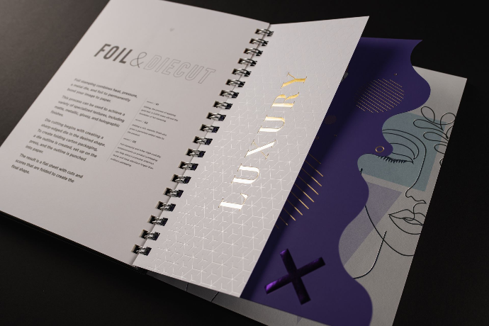 A Nice Package book spread on foil and die-cutting — foiled type beside a die-cut wave edge.