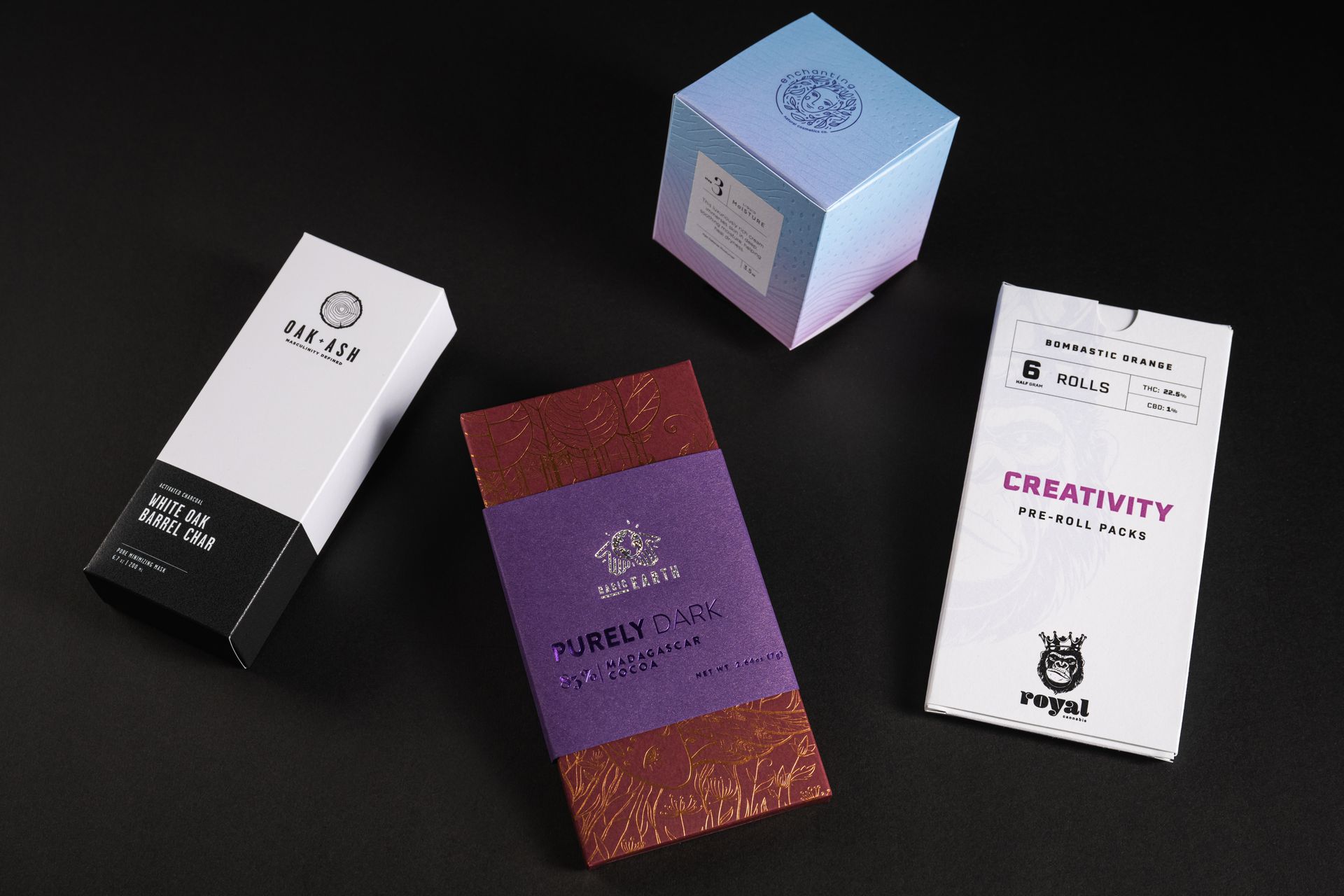Four finished packages together — a grooming carton, a chocolate bar, a cosmetics cube, and a pre-roll pack.