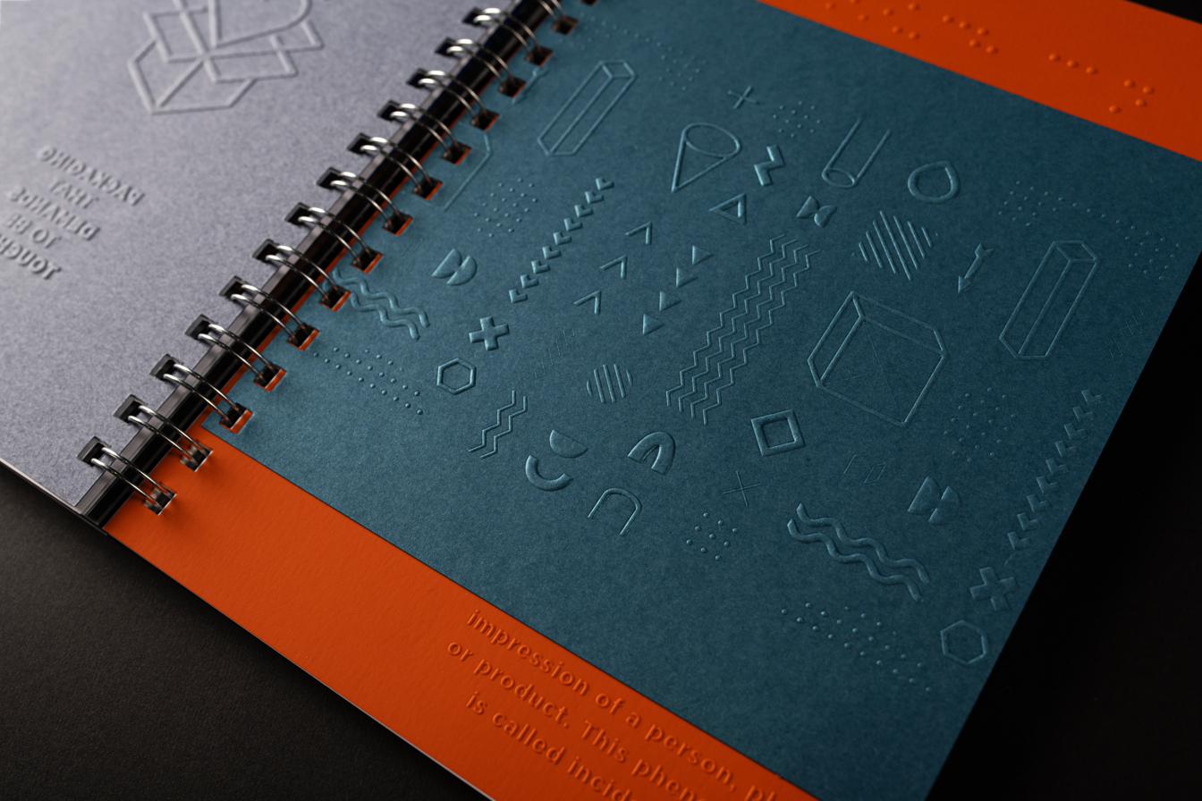 Embossing — a raking-light detail showing the finish on a real carton.
